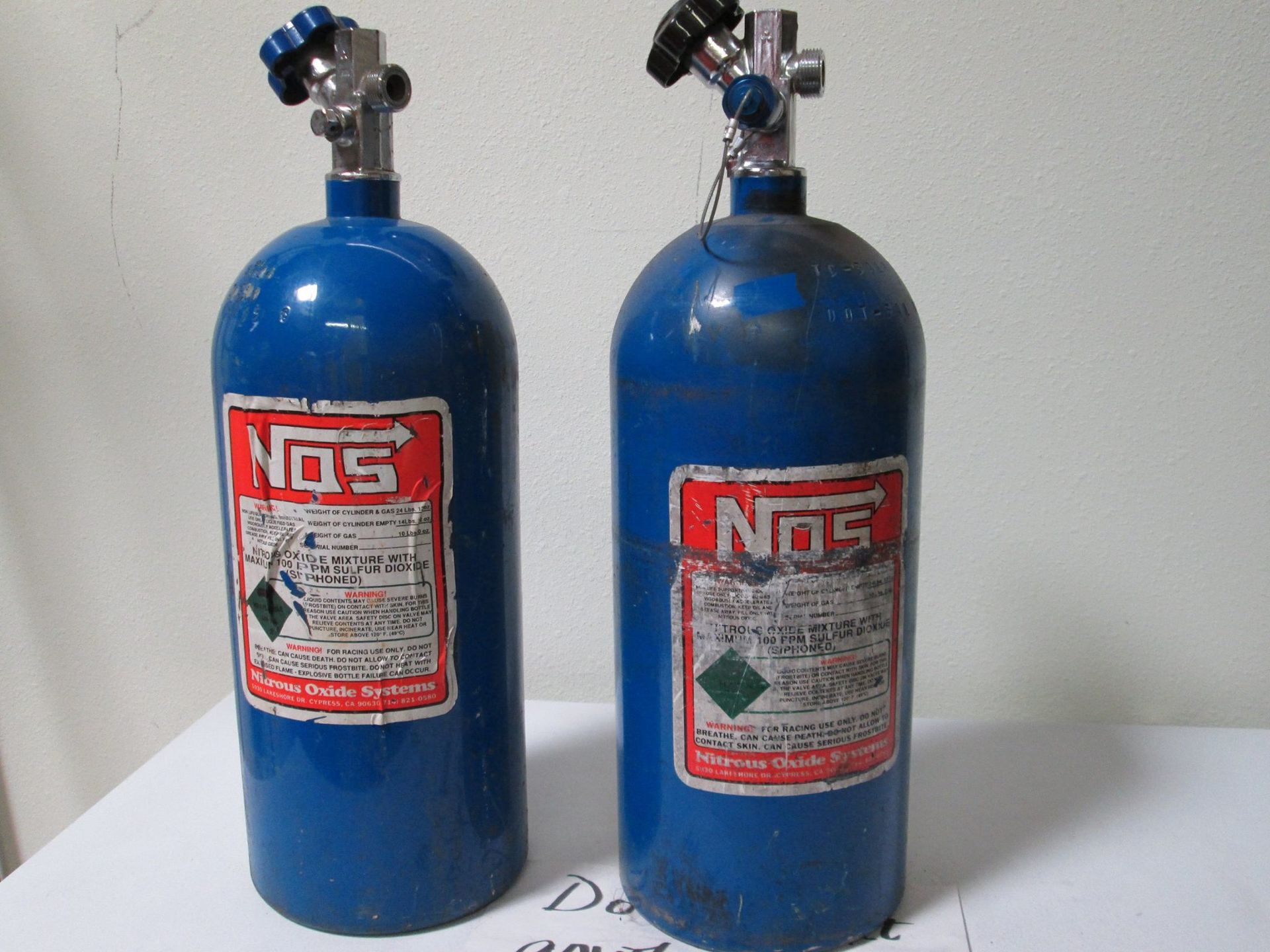 Two blue NOS nitrous oxide tanks.