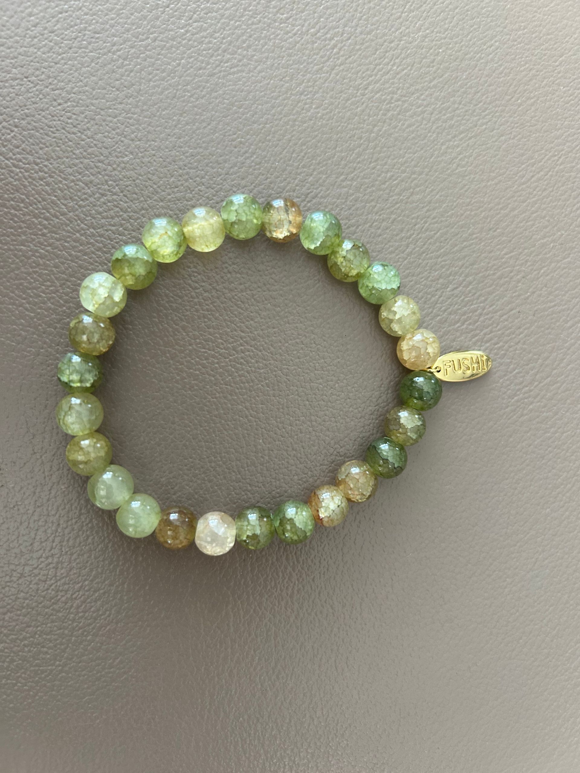 Glas kralenarmband groen met gouden bedeltje