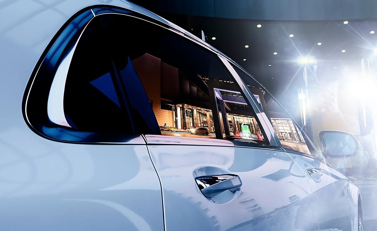 Side view of a white limousine at night.