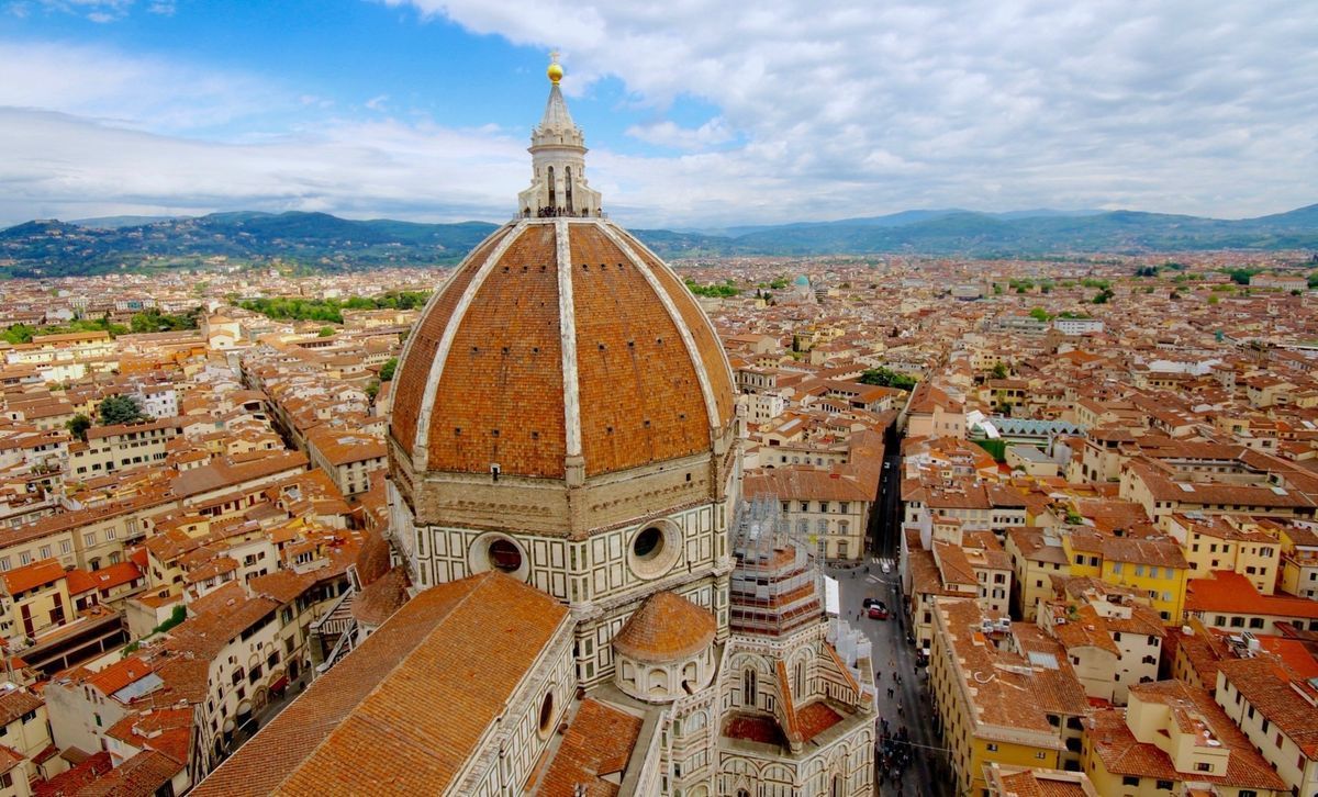 Aerial view of Florence’s red-tiled rooftops with the Duomo’s large dome centered