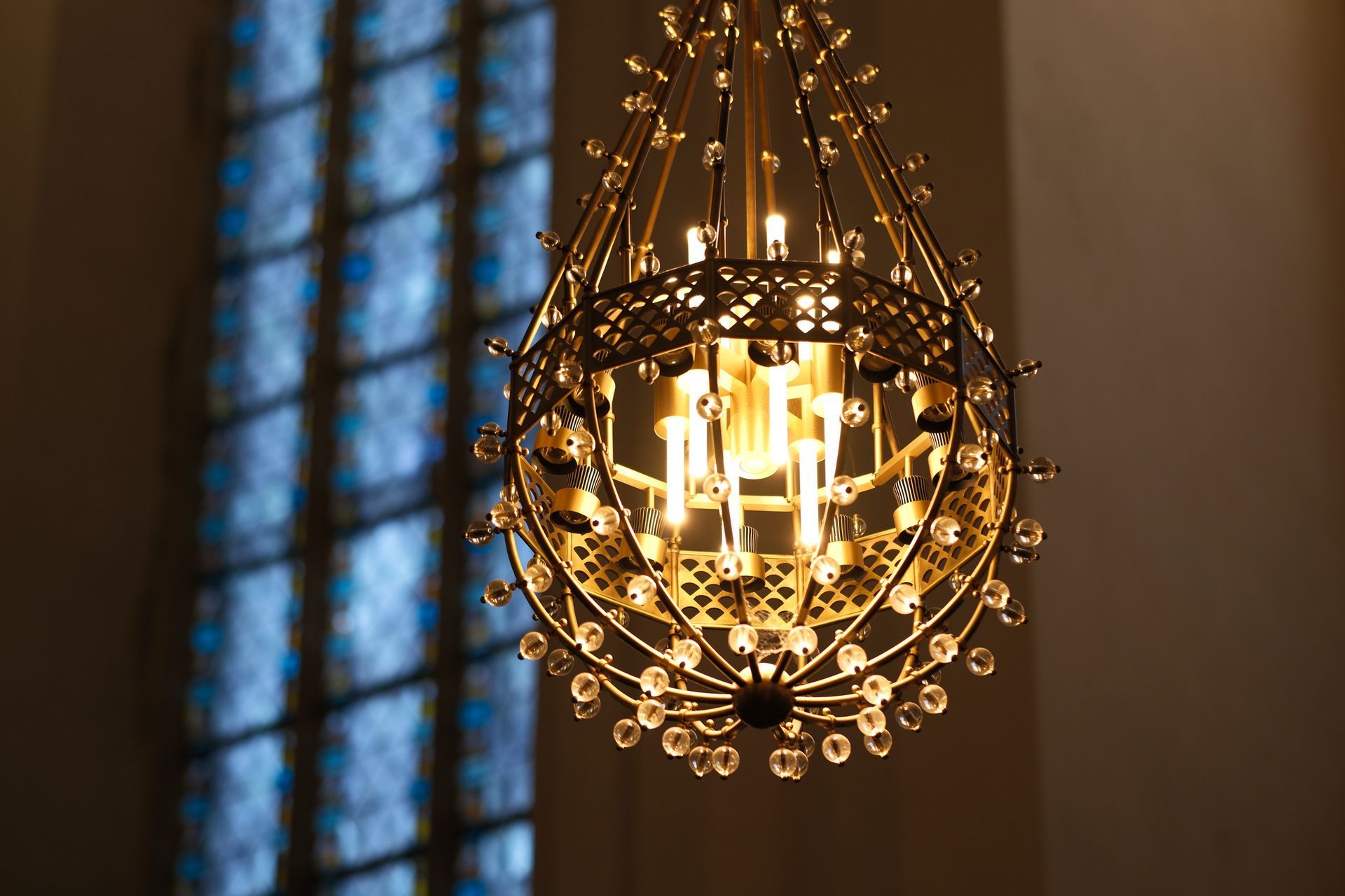 Chandelier lit in the church with background window | San Francisco, CA - CME Lighting Supply Inc.