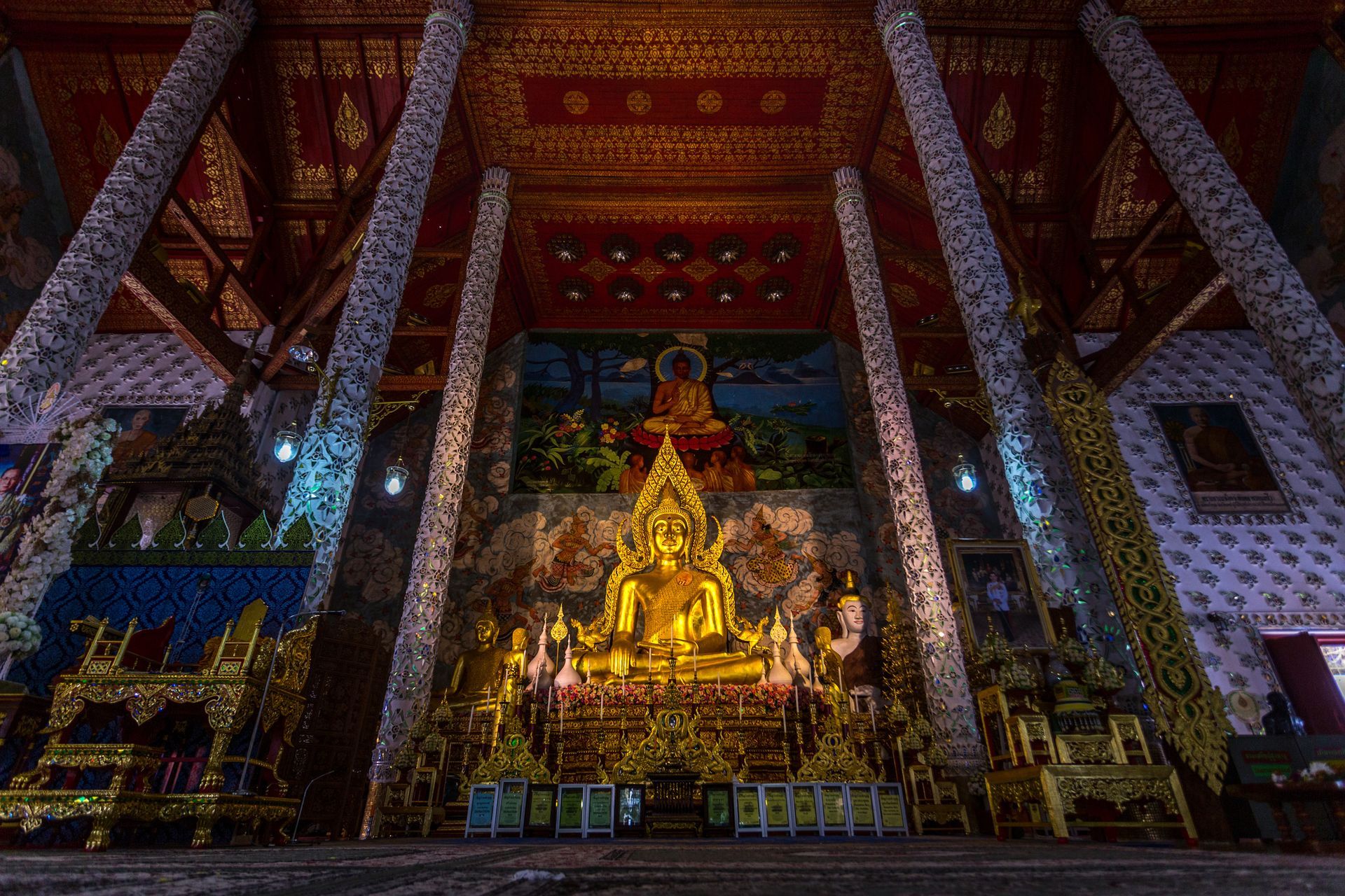 Museum gallery with large Buddha statue and glass display cases. Museum gallery with large Buddha statue and glass display cases.