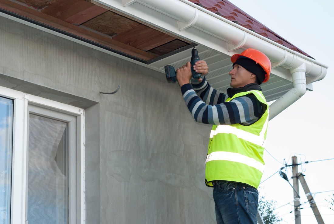 fascia and soffit contractor installing metal and vinyl siding