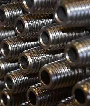 A close up of a pile of metal pipes stacked on top of each other.