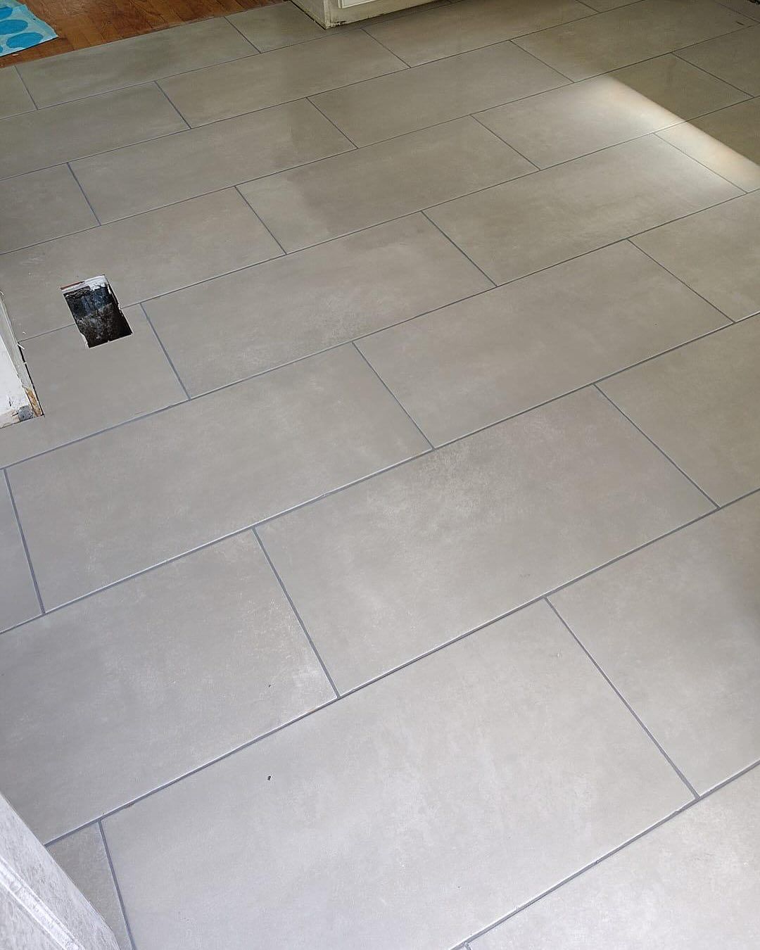 Light gray tiled floor with a small dark object near the left side