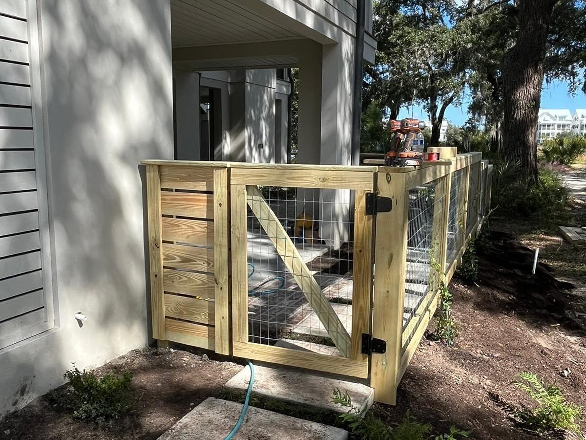 Wooden accessibility ramp with railing beside a house entrance in a shaded yard