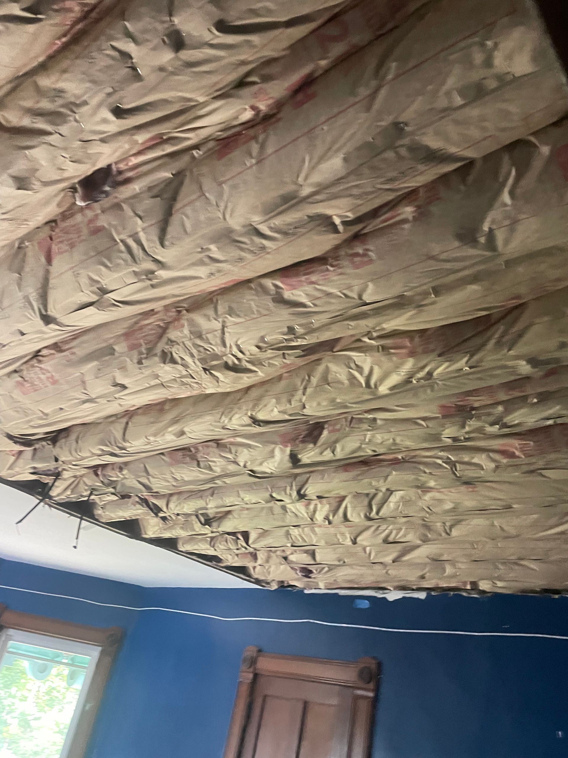 A room with a ceiling that is covered in insulation.