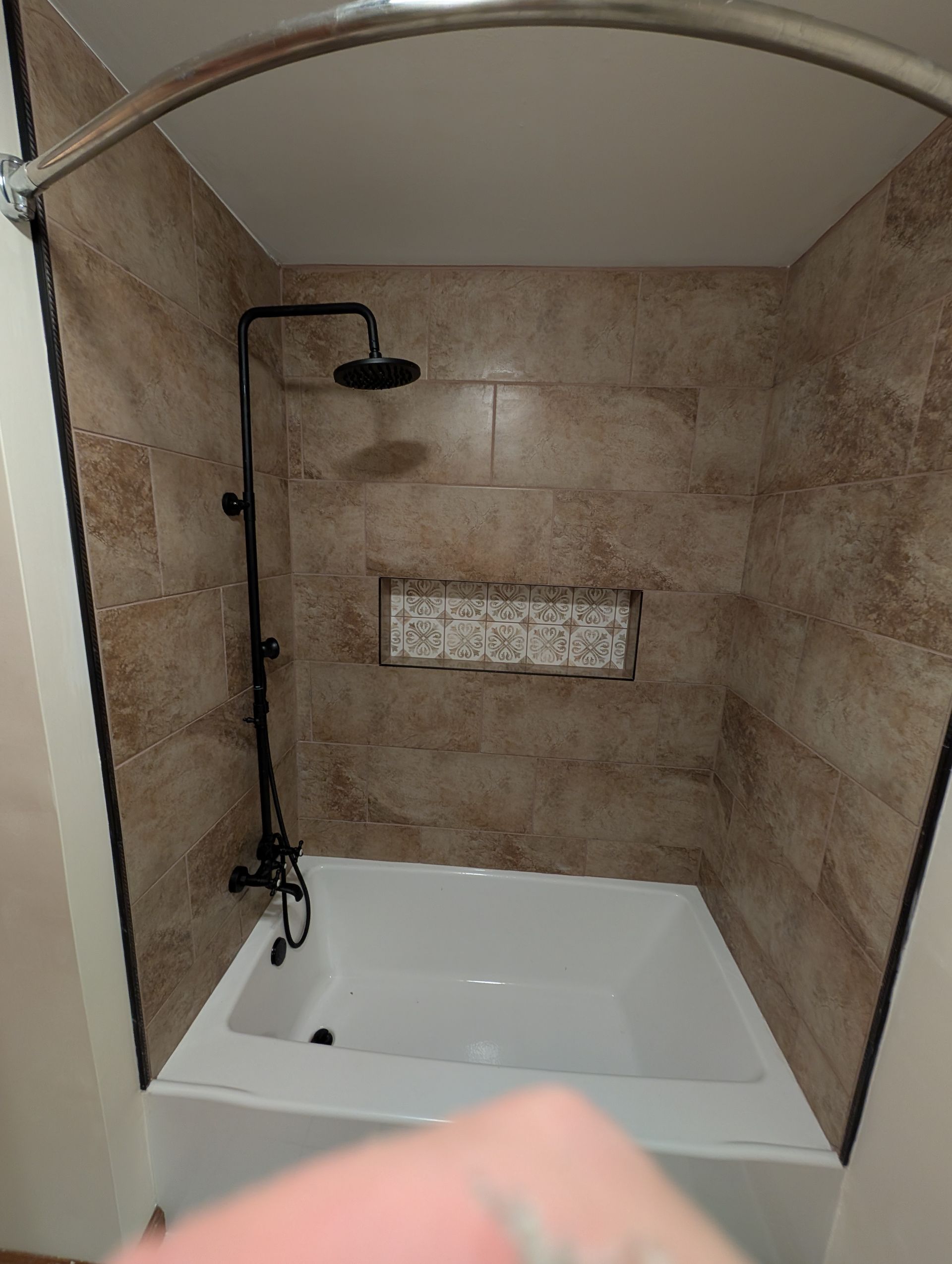 A bathroom with a bathtub and a shower.