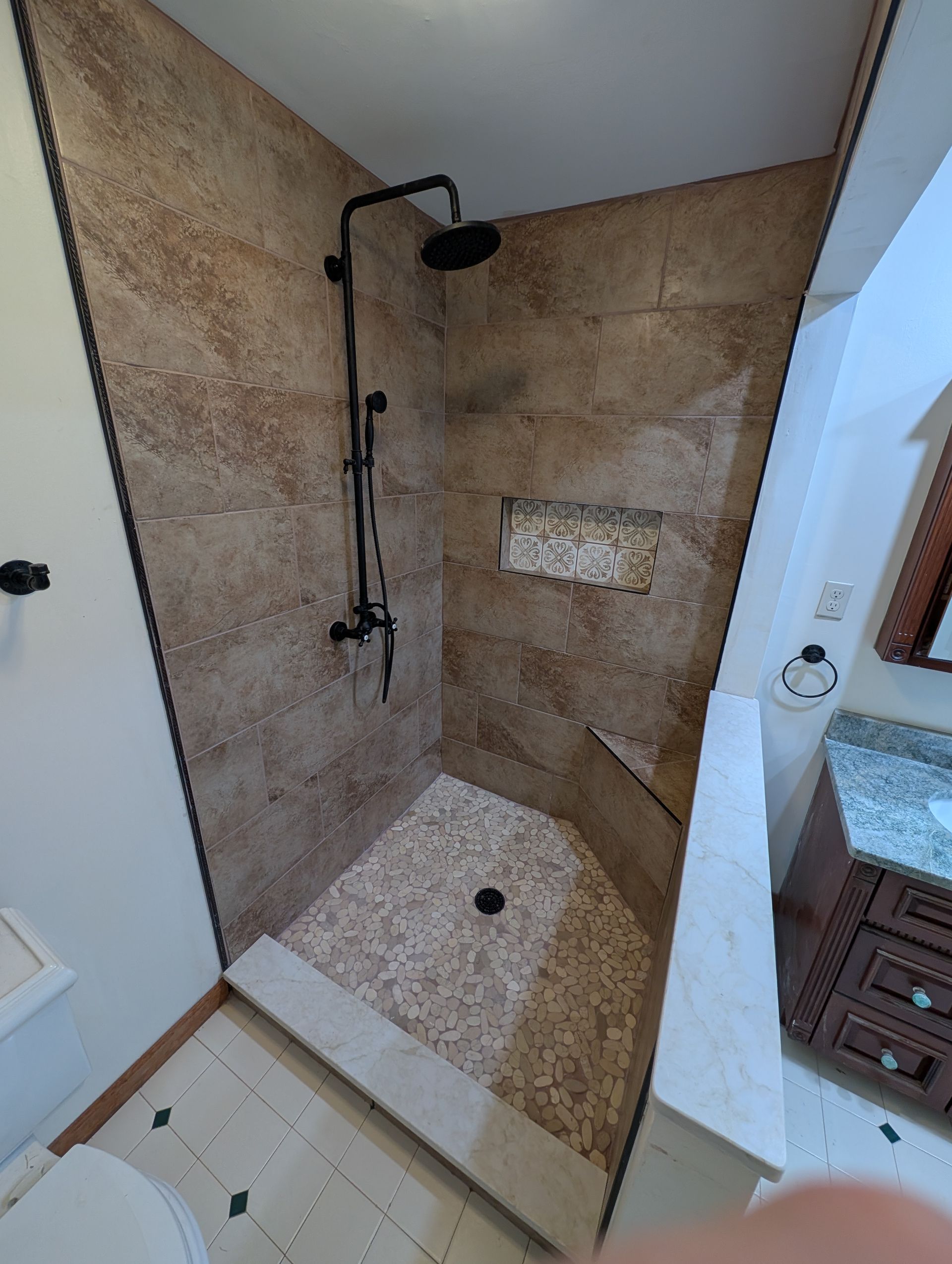 A bathroom with a walk in shower and a toilet.