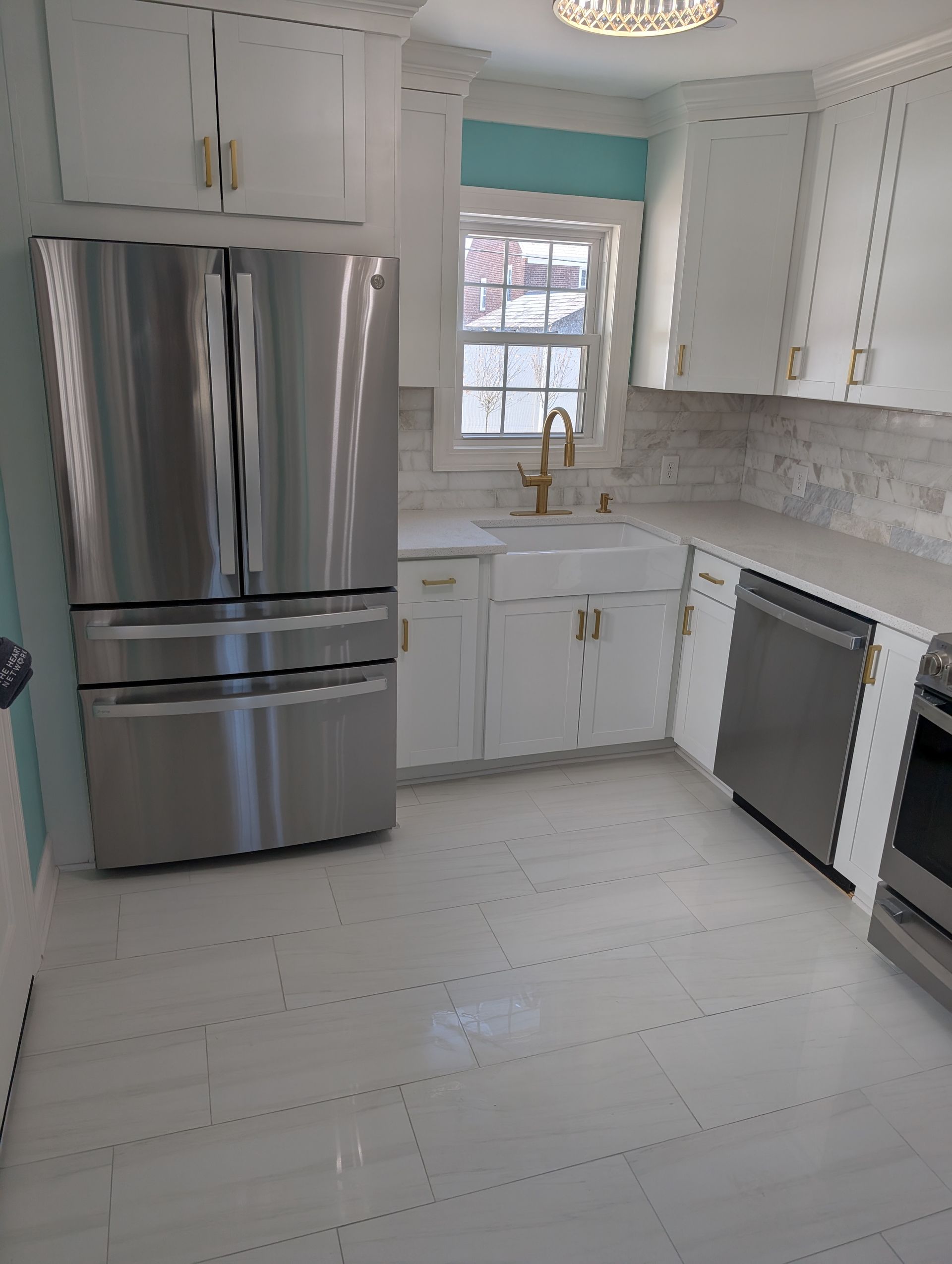 A kitchen with stainless steel appliances and white cabinets