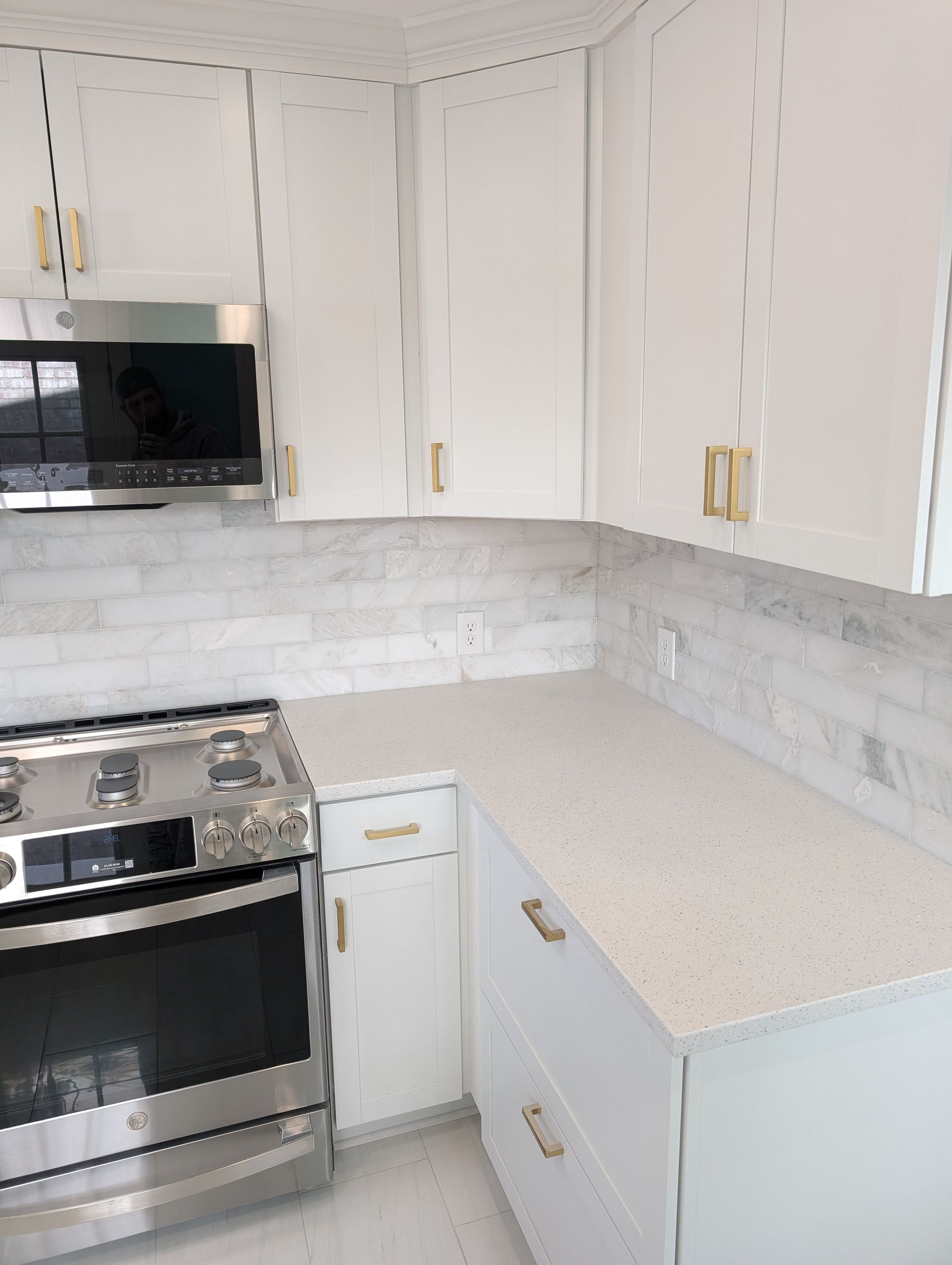 A kitchen with stainless steel appliances and white cabinets