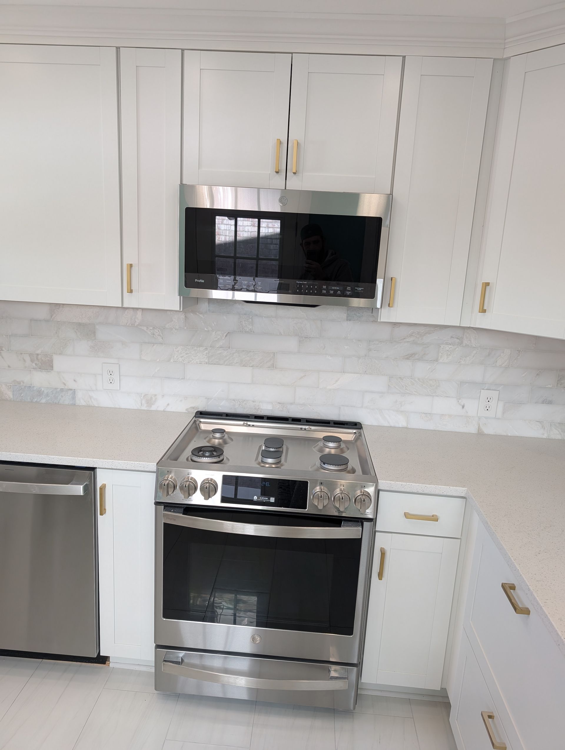 A kitchen with stainless steel appliances and white cabinets