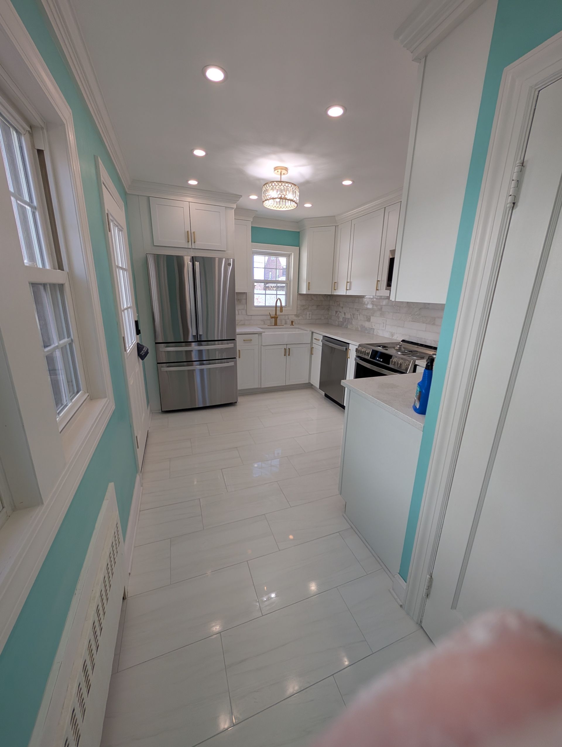 A kitchen with white cabinets and stainless steel appliances
