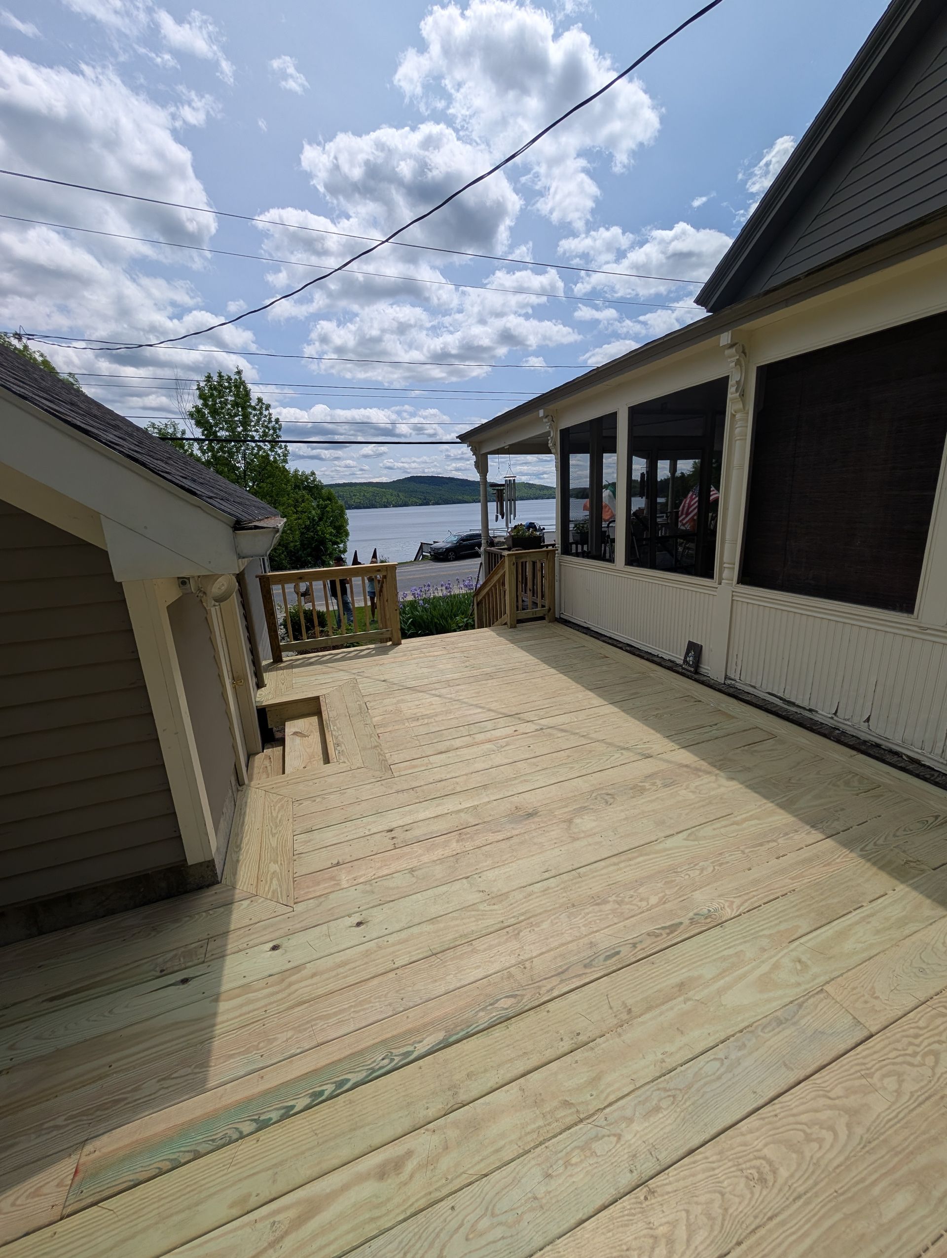 A wooden deck is being built on the side of a house.