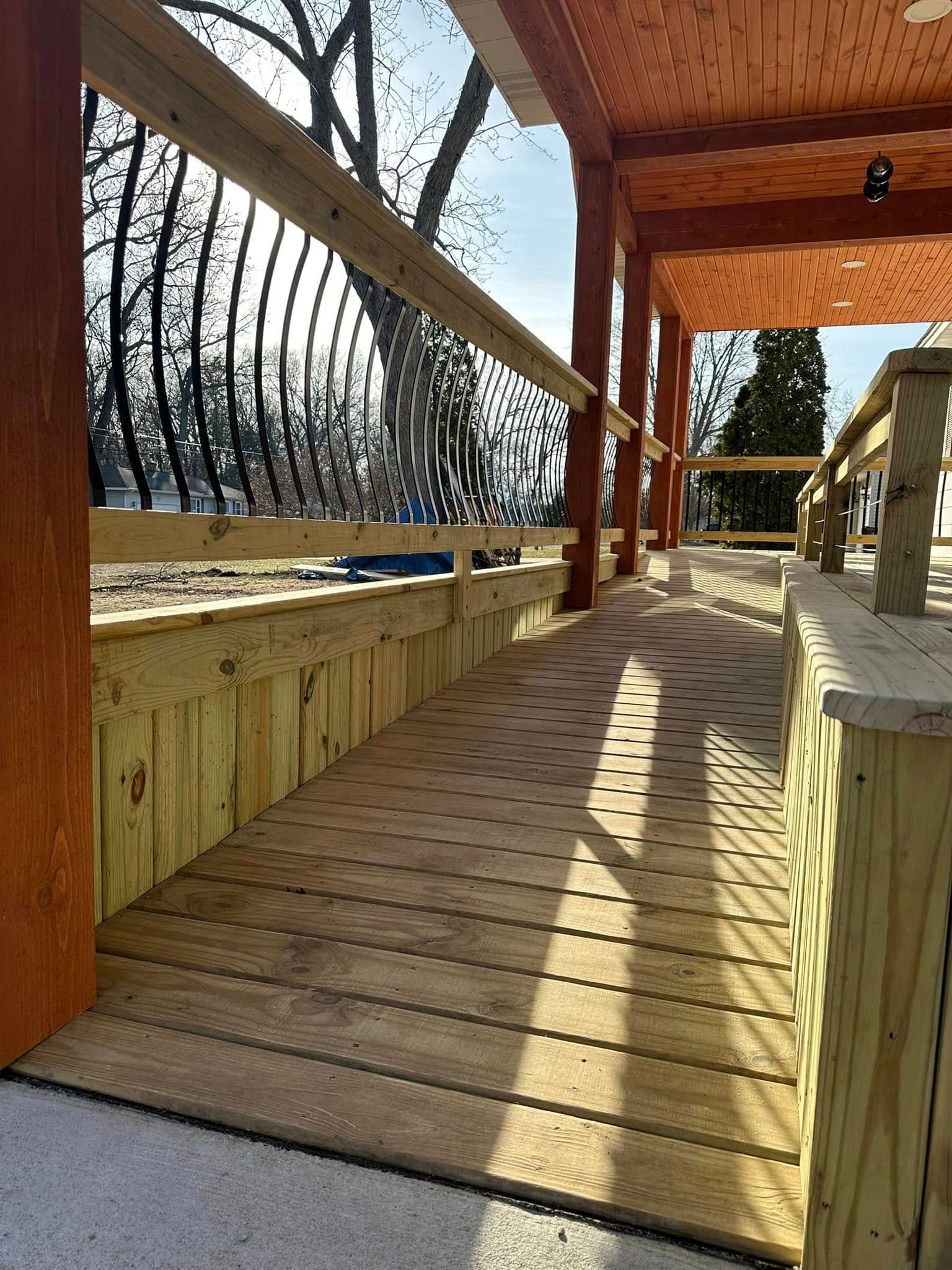 Wooden boardwalk with railing and netting along a sunny outdoor deck