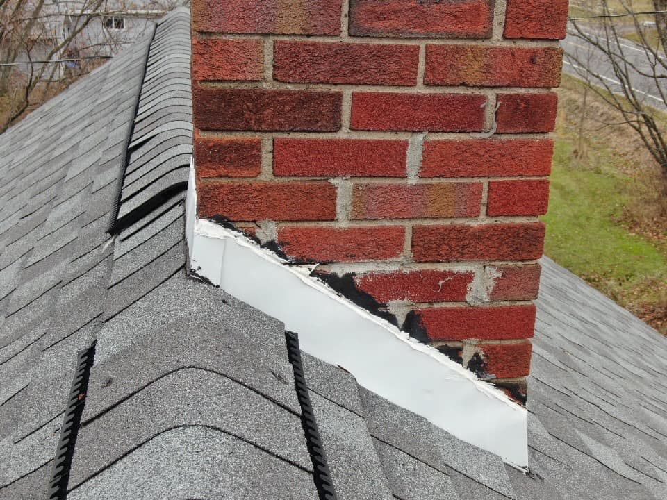 Brick chimney flashing repair on a shingled roof
