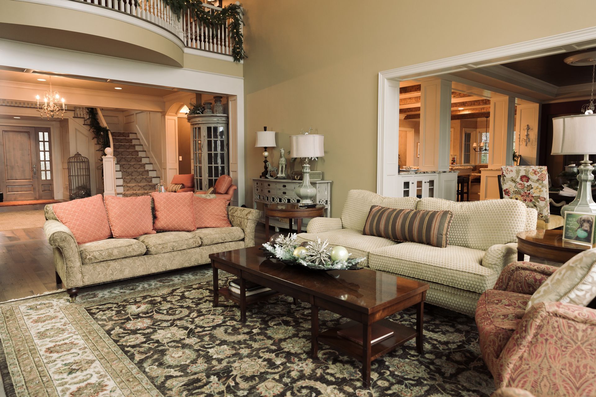 Living room with sofas, rug, coffee table, and open entry to dining area, beige walls.
