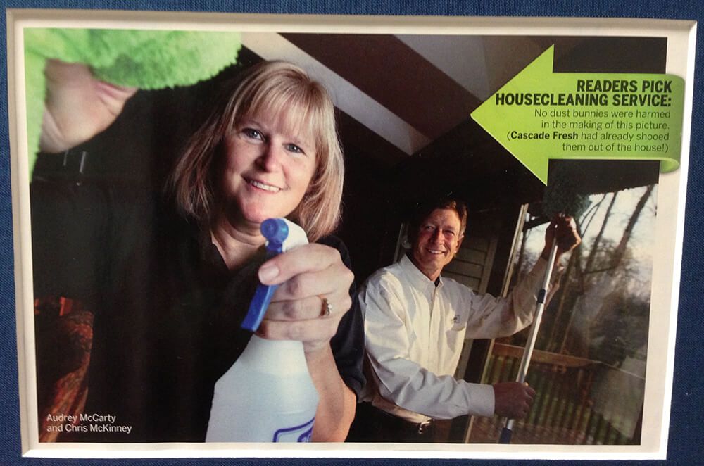 Woman sprays cleaner; man cleans window. Housecleaning service ad.