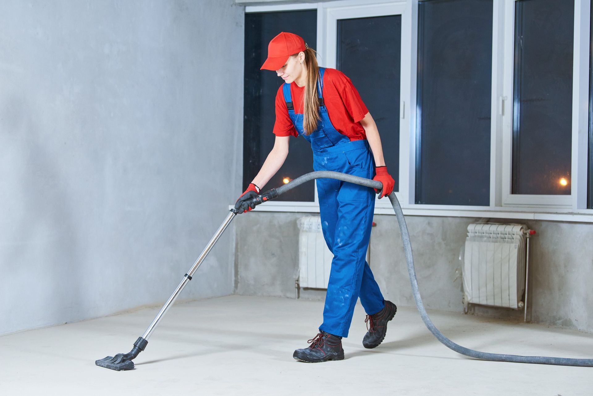 a woman is cleaning the floor with a vacuum cleaner