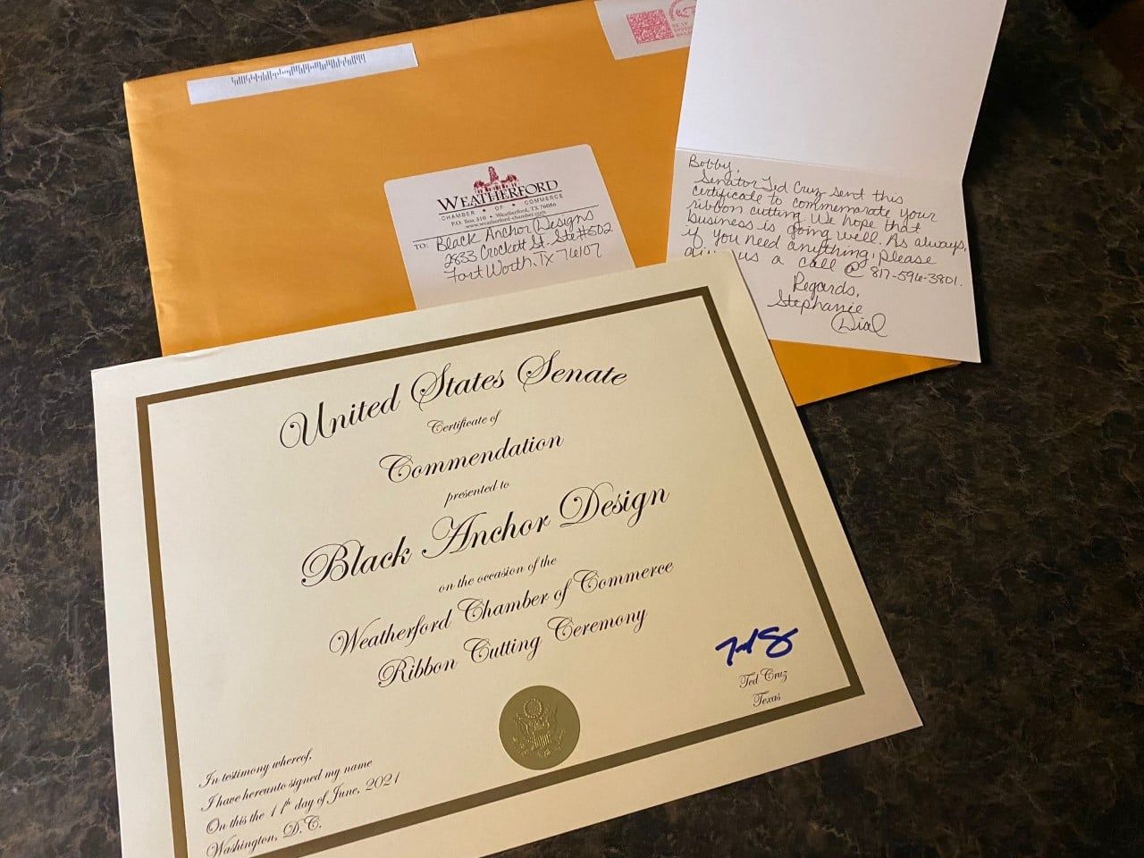 A united states army certificate is next to an envelope