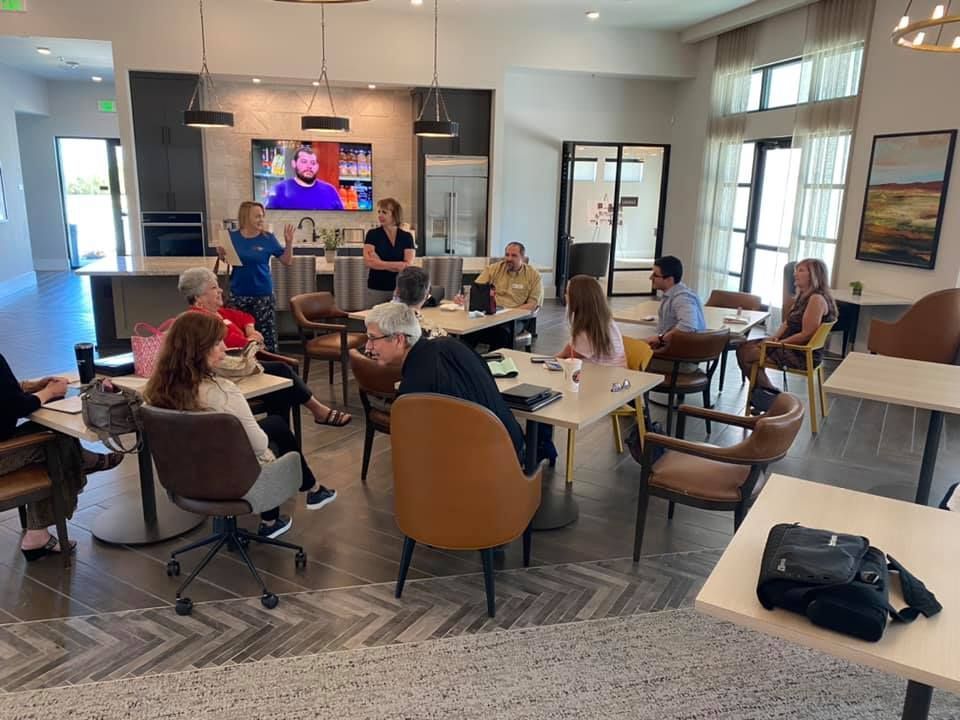 Black Anchor Design at Benbrook Business Exchange A group of people are sitting at tables in a room.
