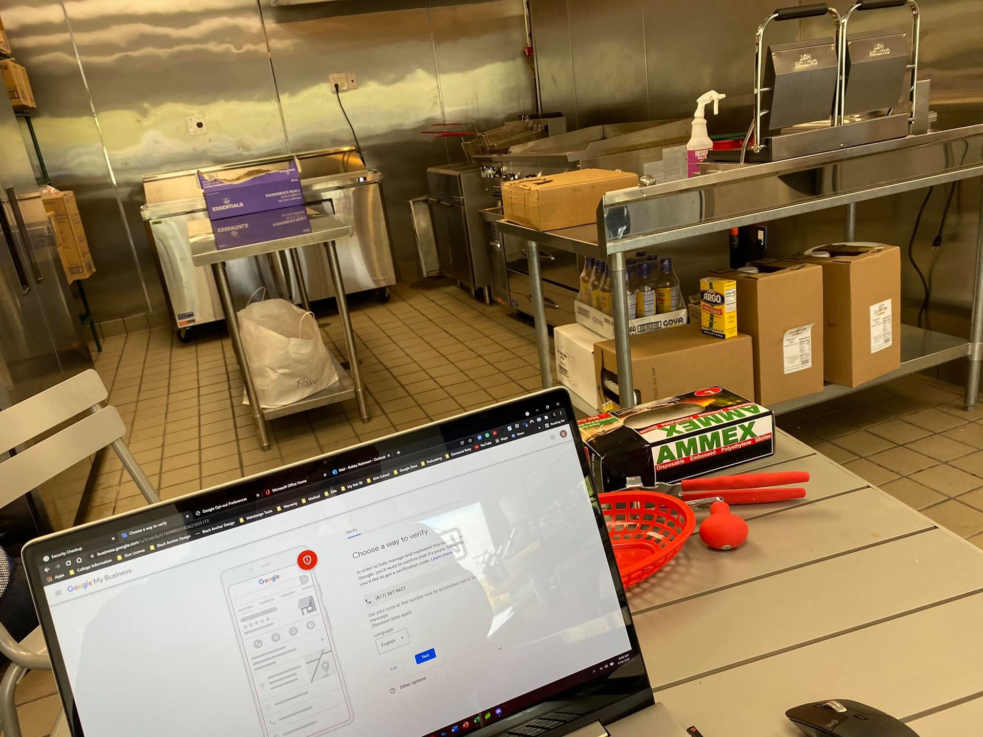 A laptop computer is sitting on a table in a kitchen.