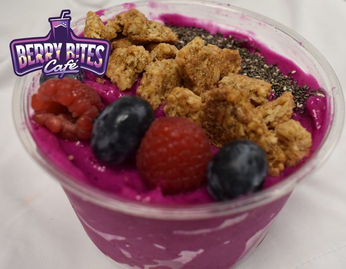 A bowl of berry bites cafe with berries and granola