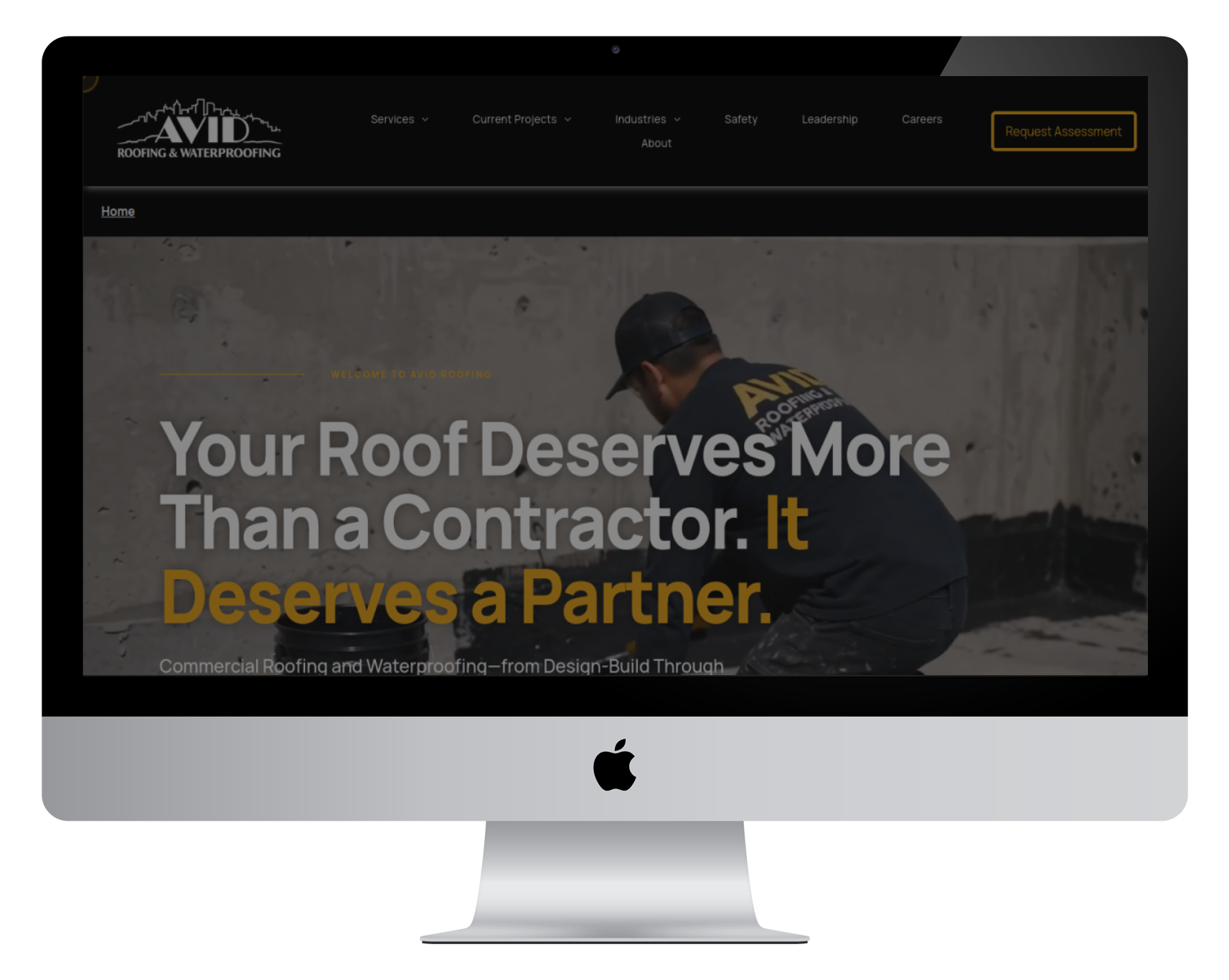 Desktop monitor showing a roofing company website with the headline “Your Roof Deserves More Than a Contractor. It Deserves a Partner.”