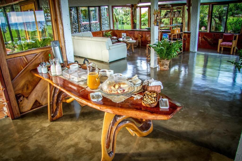 A wooden table with a lot of food on it in a room.