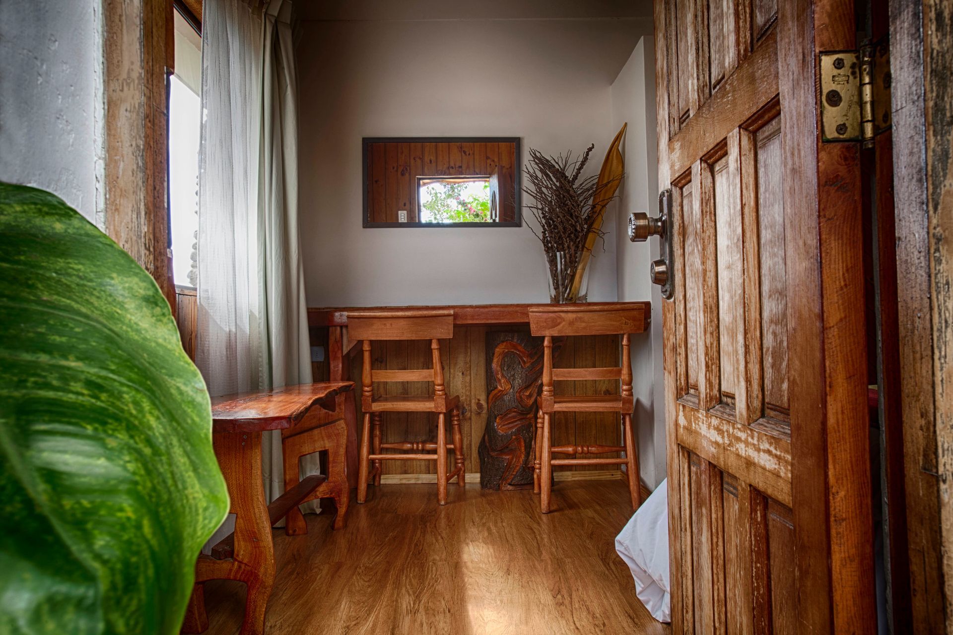 A bedroom with a large bed and a small table