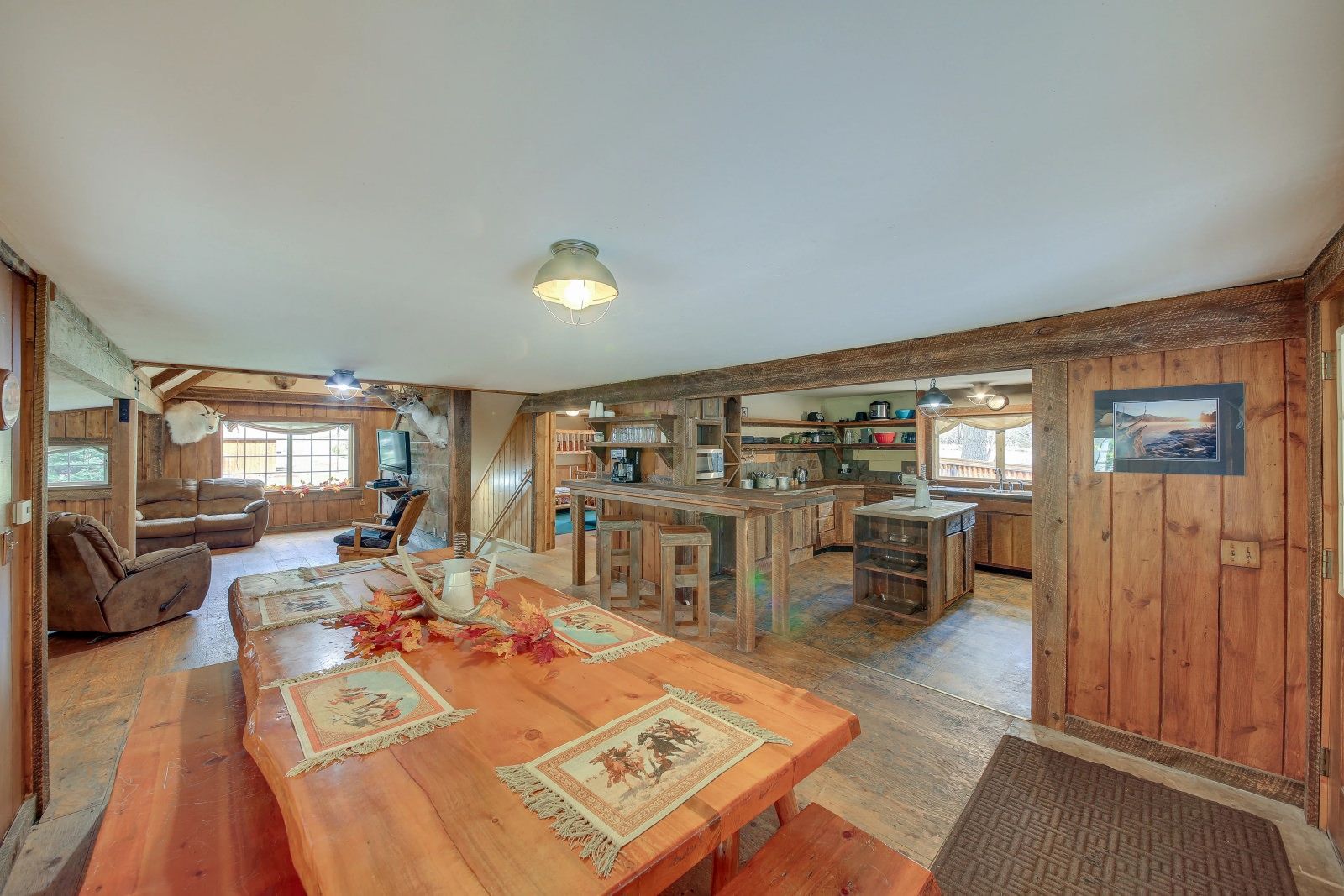There is a large wooden table in the middle of the room.