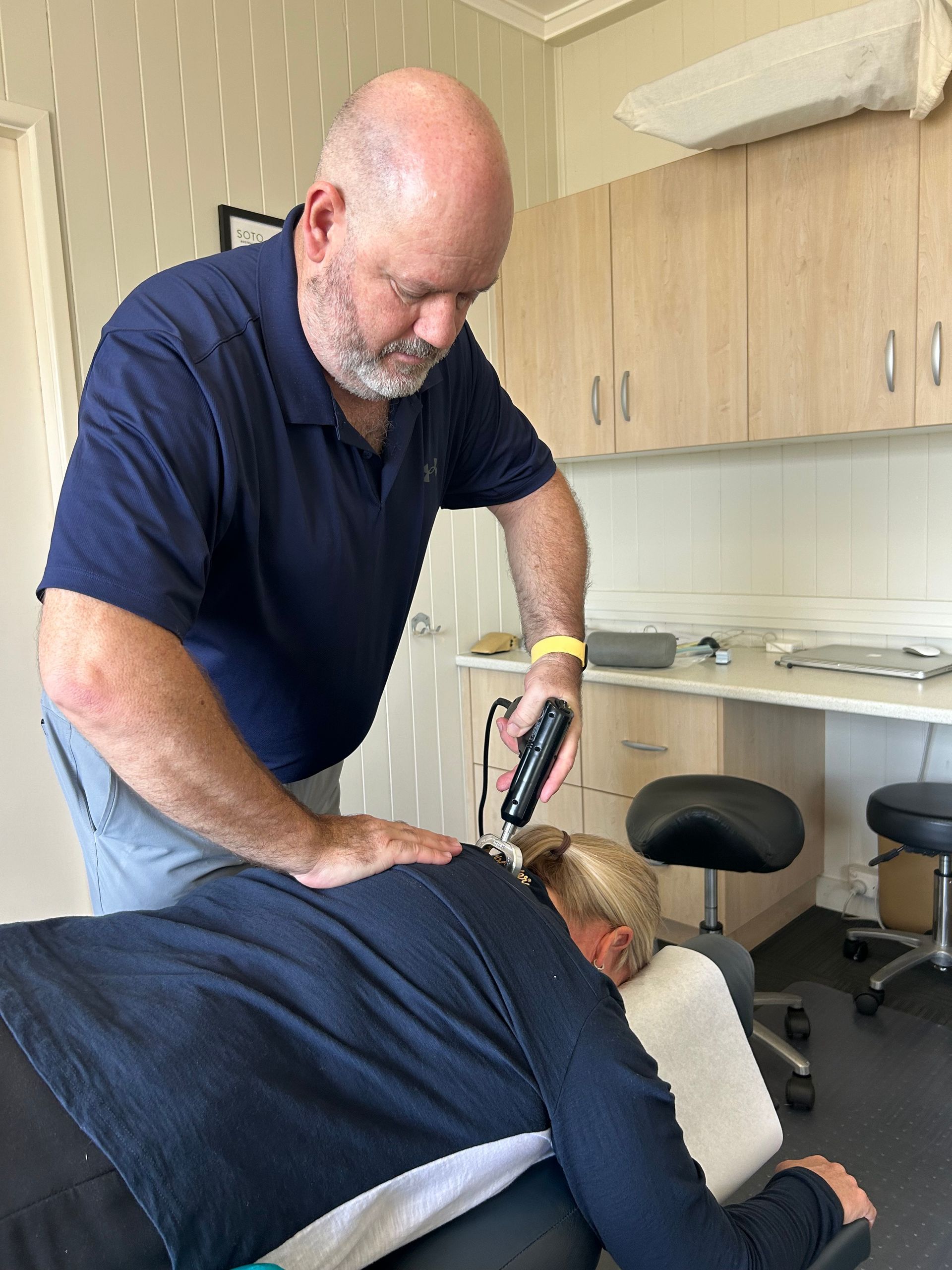 A Person Performing a Treatment on Another Person — Wide Bay Chiropractic in Gympie, QLD