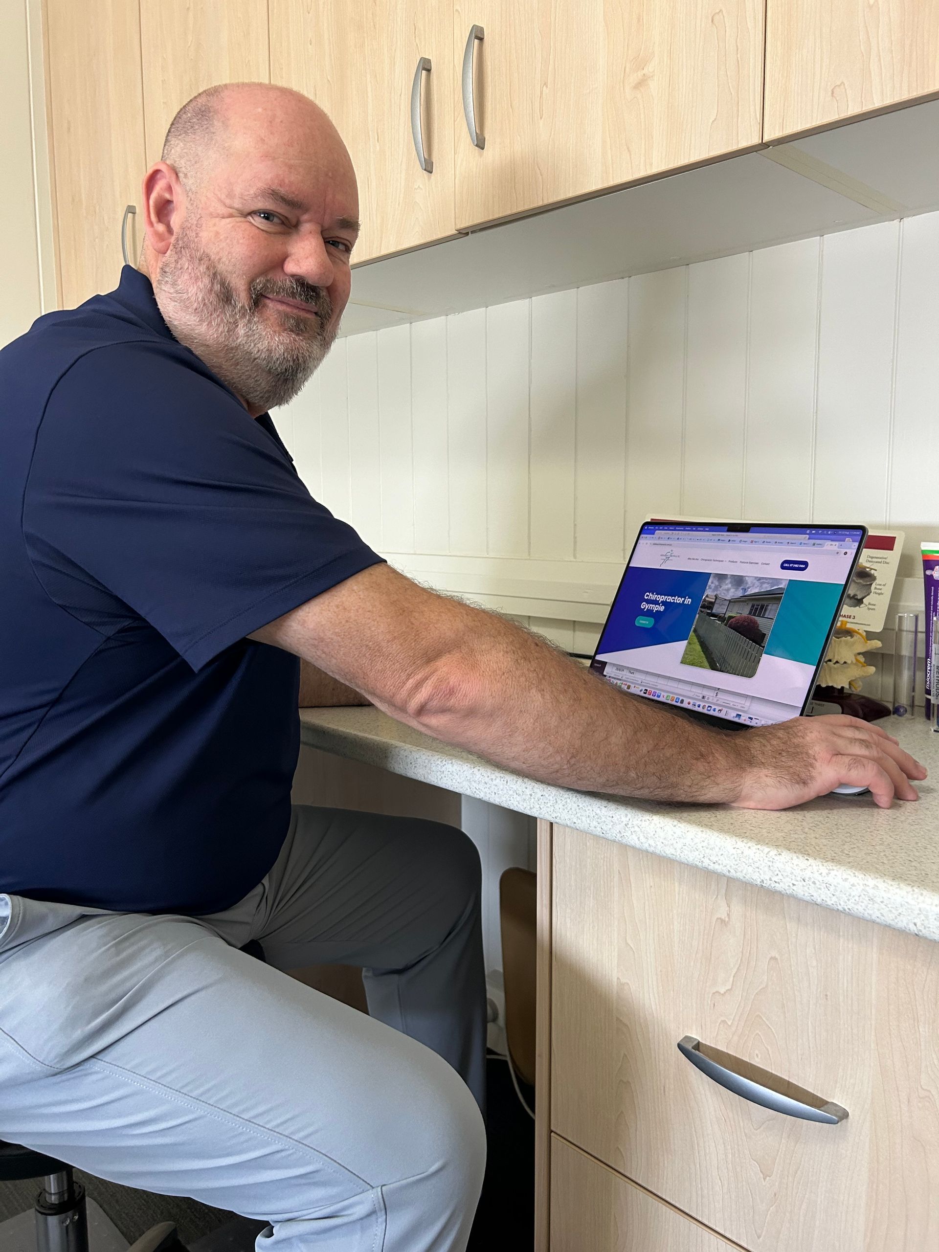 Man Seated at Desk — Wide Bay Chiropractic in Gympie, QLD