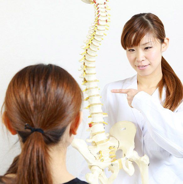Woman Pointing at Spinal Model — Wide Bay Chiropractic in Gympie, QLD