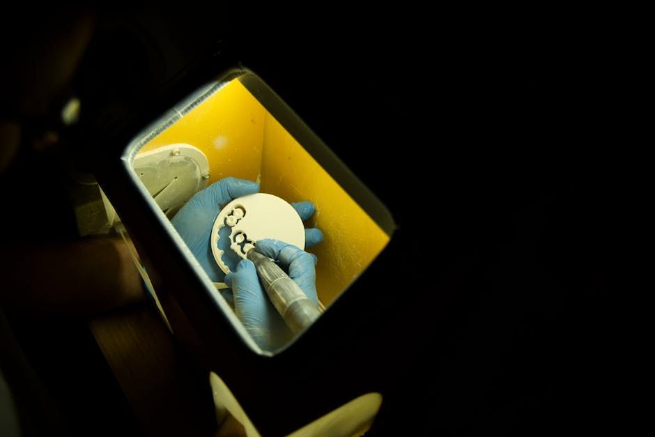 Yellow-lit tray with a small blue-and-white toy figure inside a dark compartment