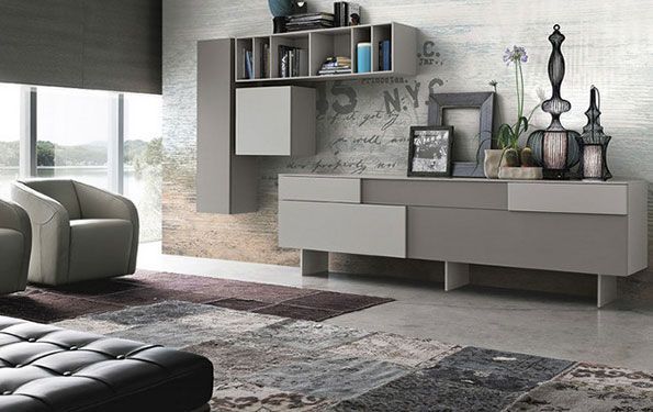 Soggiorno moderno con mobili grigi, tappeto e opere d'arte contro una parete strutturata.