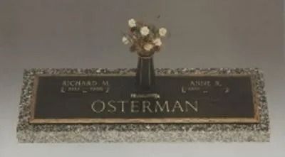 Gravestone plaque with flowers, engraved with the name Osterman.