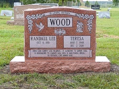 Wood gravestone with names Randall Lee and Teresa in a cemetery grassy setting.
