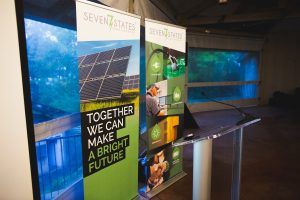 A podium with two posters on it that say `` together we can make a bright future ''.