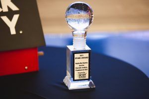 A trophy with a glass ball on top of it is sitting on a table.