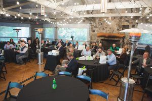 A group of people are sitting at tables in a room.