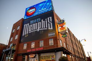 A large billboard on the side of a building says big memphis.