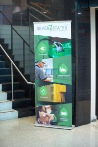A seven states banner is hanging on a wall next to stairs