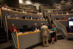 A group of people are sitting in a large auditorium.