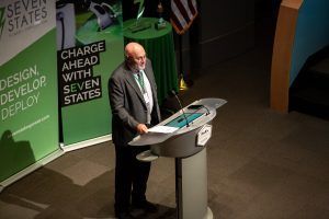A man is standing at a podium giving a speech.