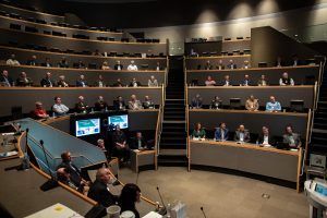 A group of people are sitting in a large auditorium.