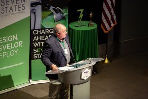 A man is standing at a podium giving a speech.