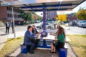A group of people are sitting at a picnic table.