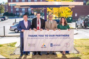 A group of people are holding a thank you to our partners sign.