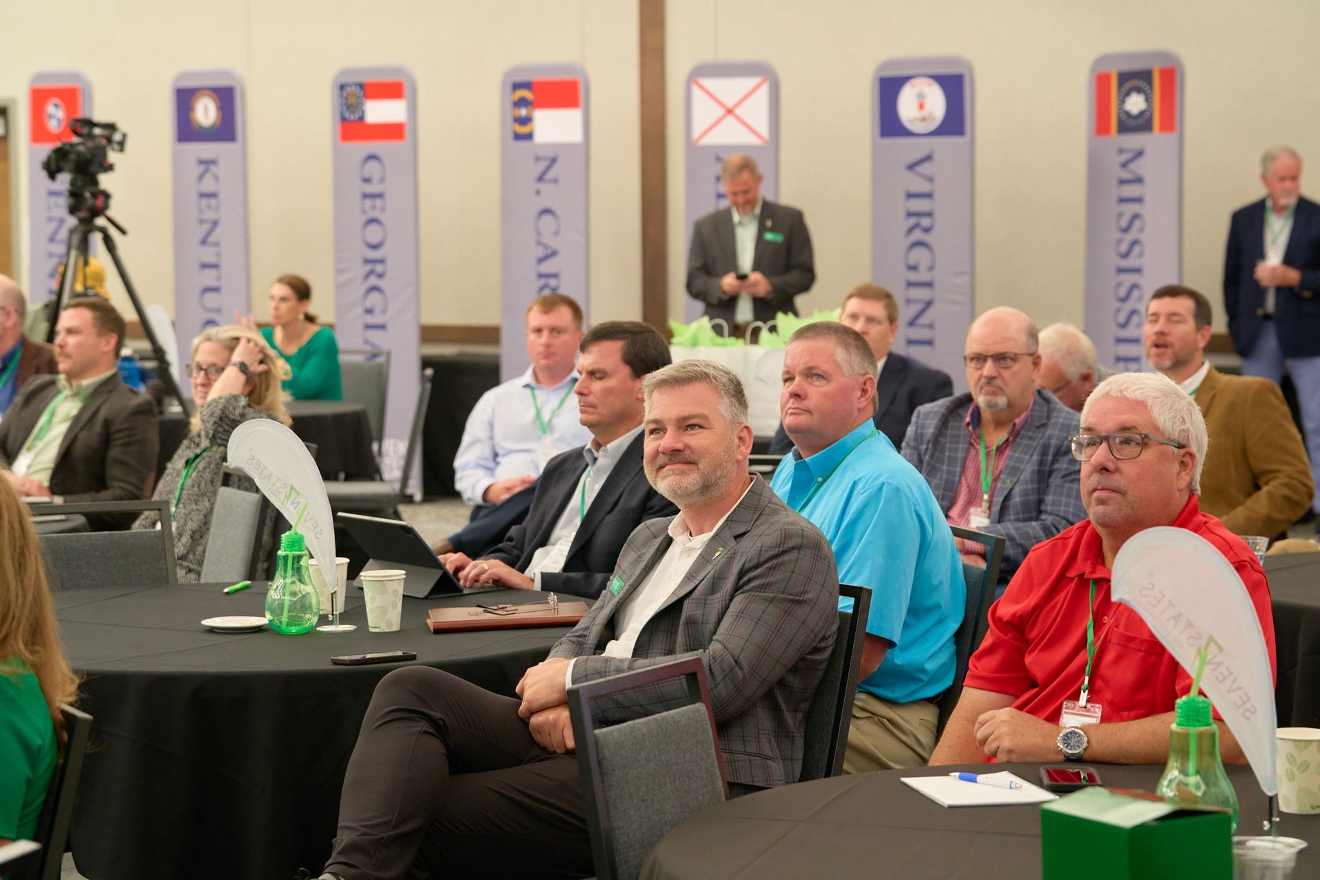 A group of people are sitting at tables in a room.